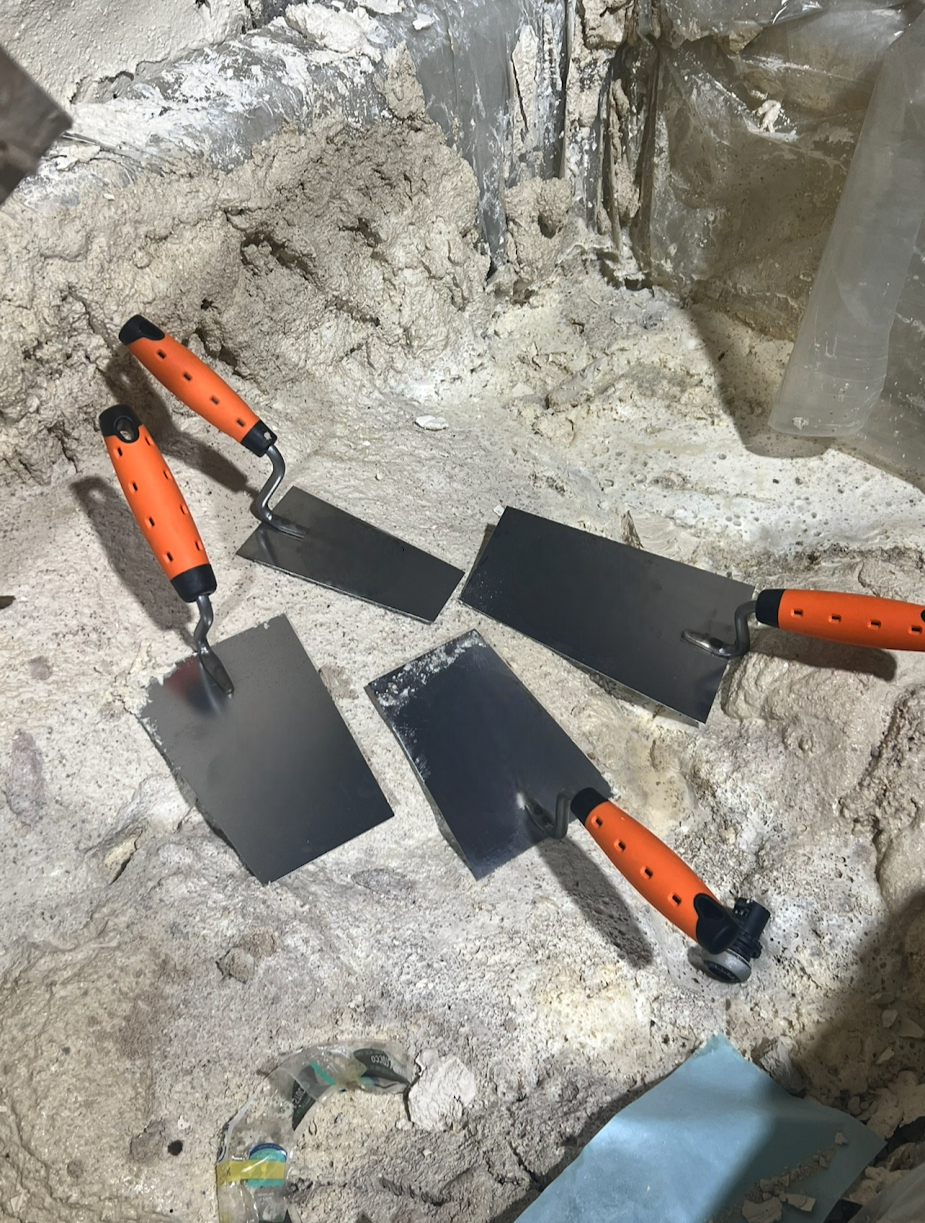 plastering work using stainless steel bucket trowel