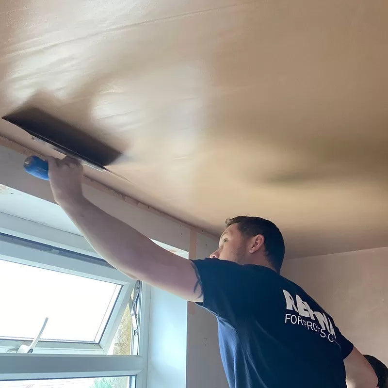 plasterer skimming a ceiling with a refina superflex plastering trowel