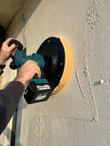 Plasterer using Skimflex battery power float to level mesh coat